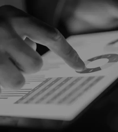 Person analyzing data charts on a digital tablet.