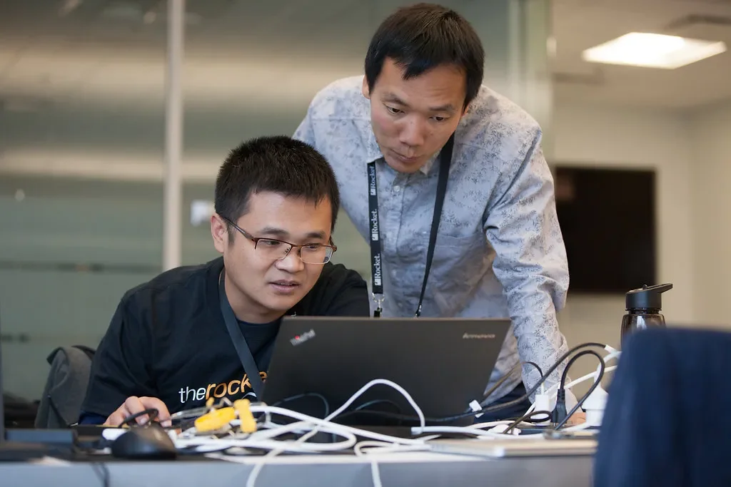 Two people working on the computer
